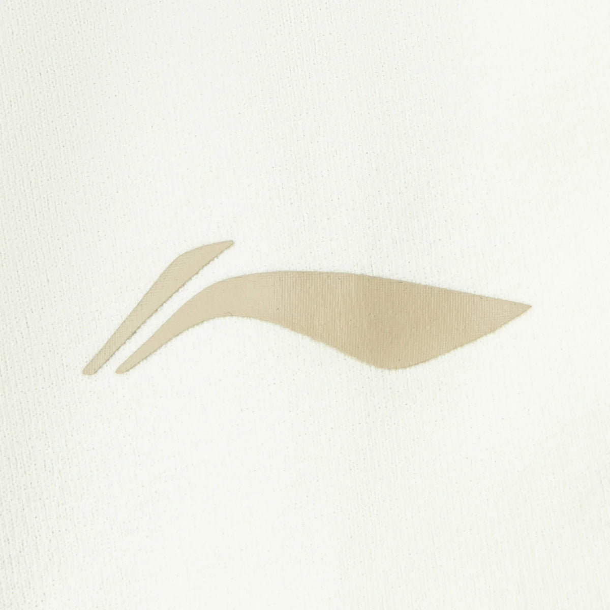 Haut manches longues femme Li-Ning : gros plan sur le logo Li-Ning beige imprimé sur le tissu écru